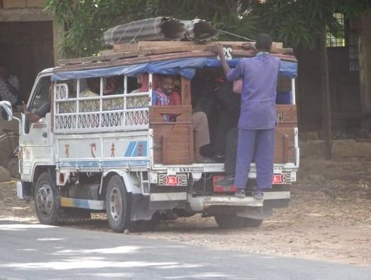 A white Dada dala carrying passengers in Zanzibar